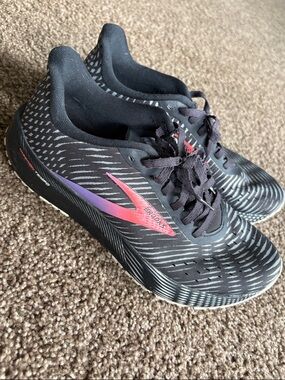 Brooks Black Running Shoes with hot orange-to-Purple Logo. Women size 8.5.